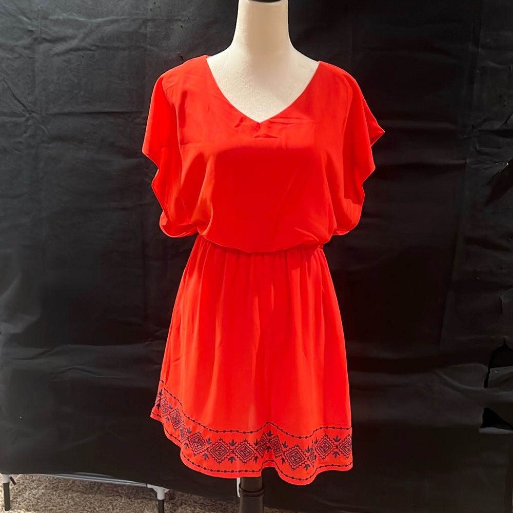 Cute orange blouse dress with flowy sleeves and navy embroidery. By Miami